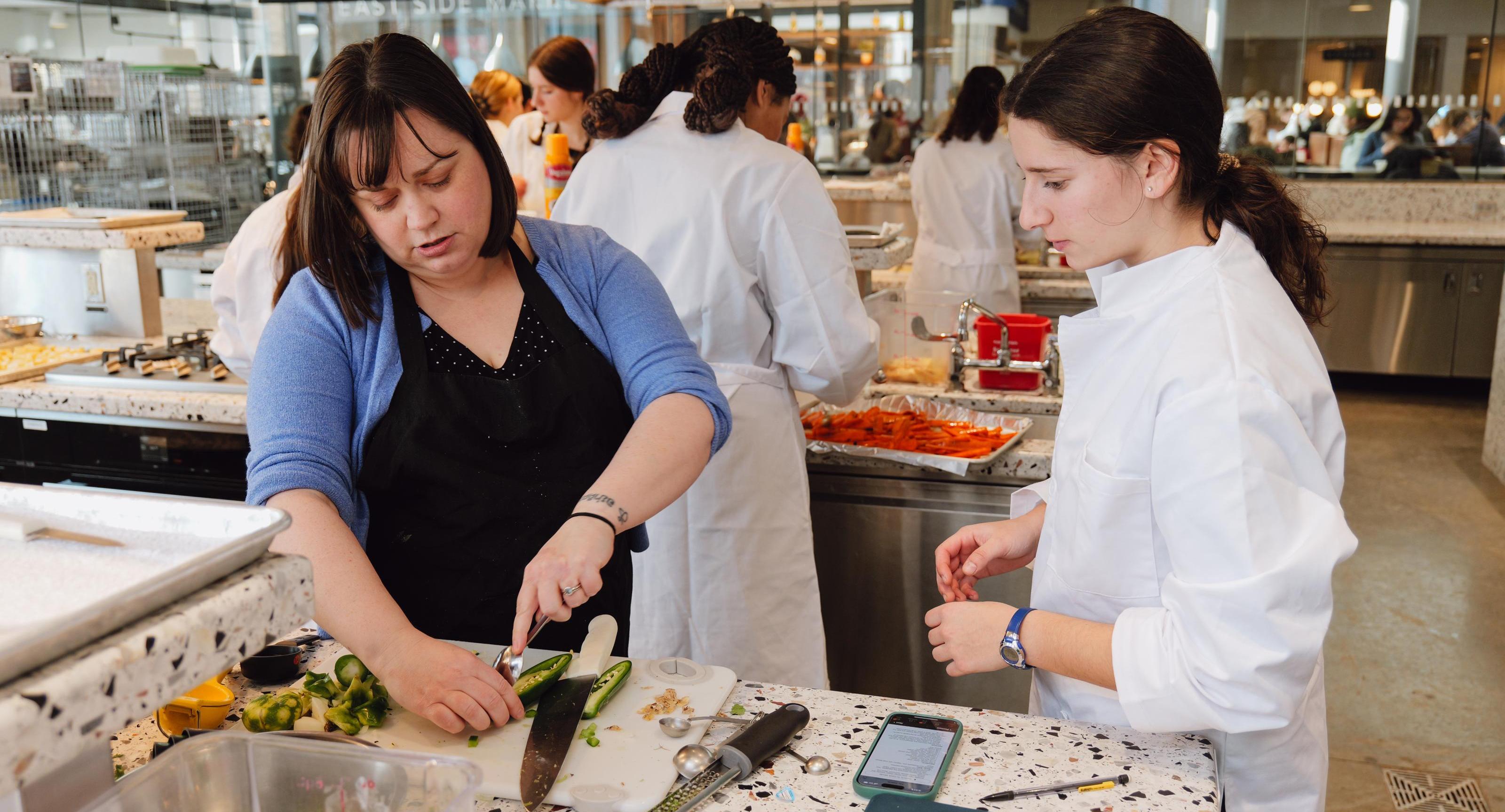 Student working with instructor Erin Green in the Discovery Kitchen.