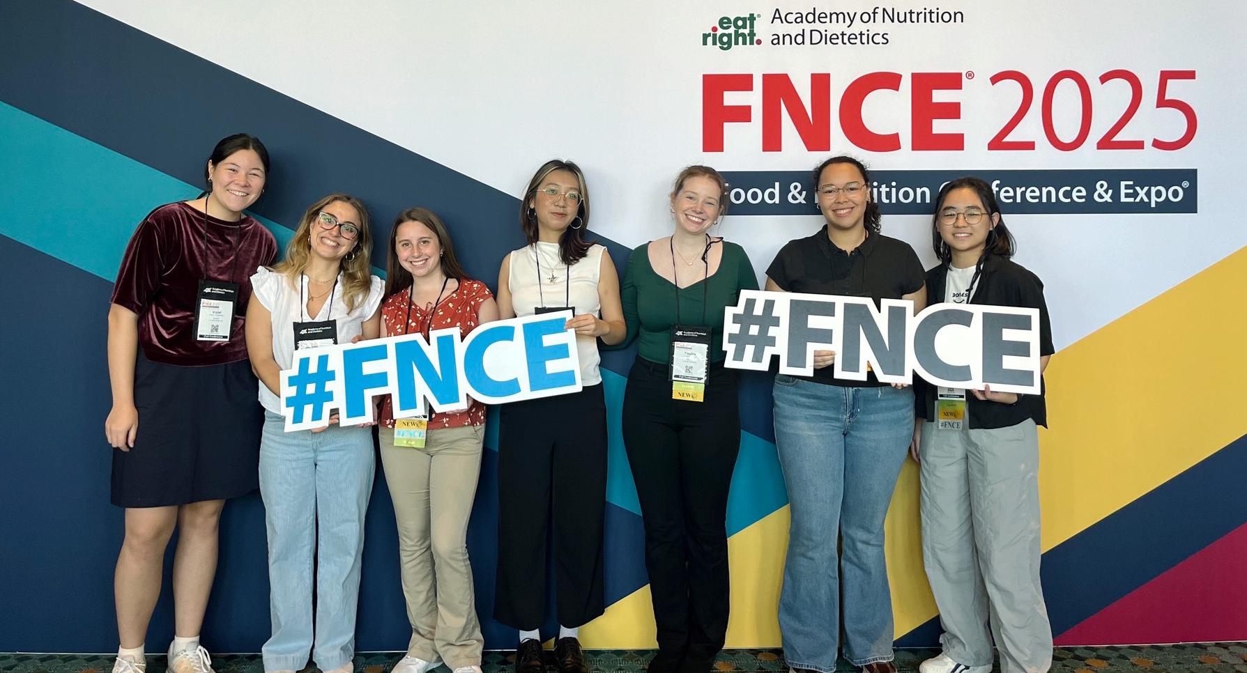Group photo infront of FNCE 2025 sign