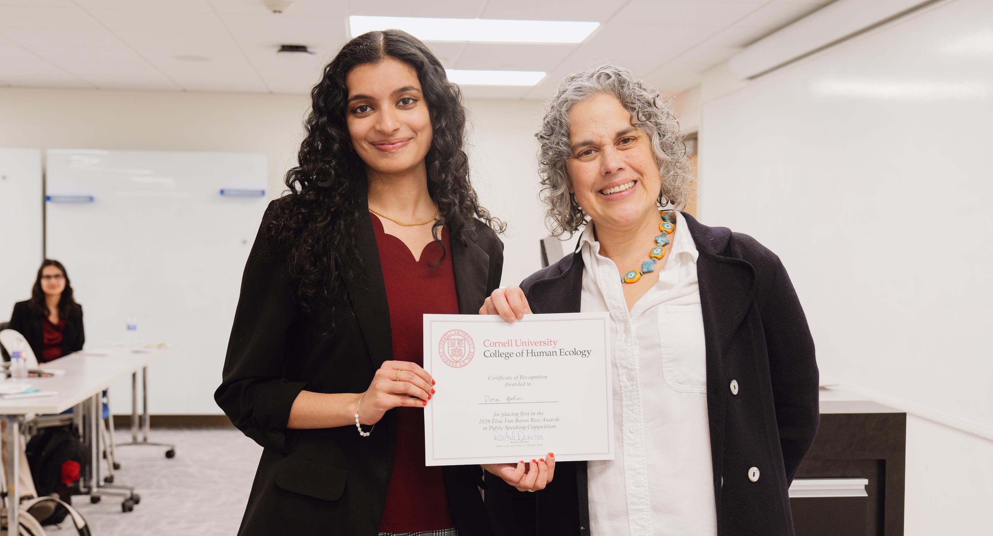 Dora John receiving an award