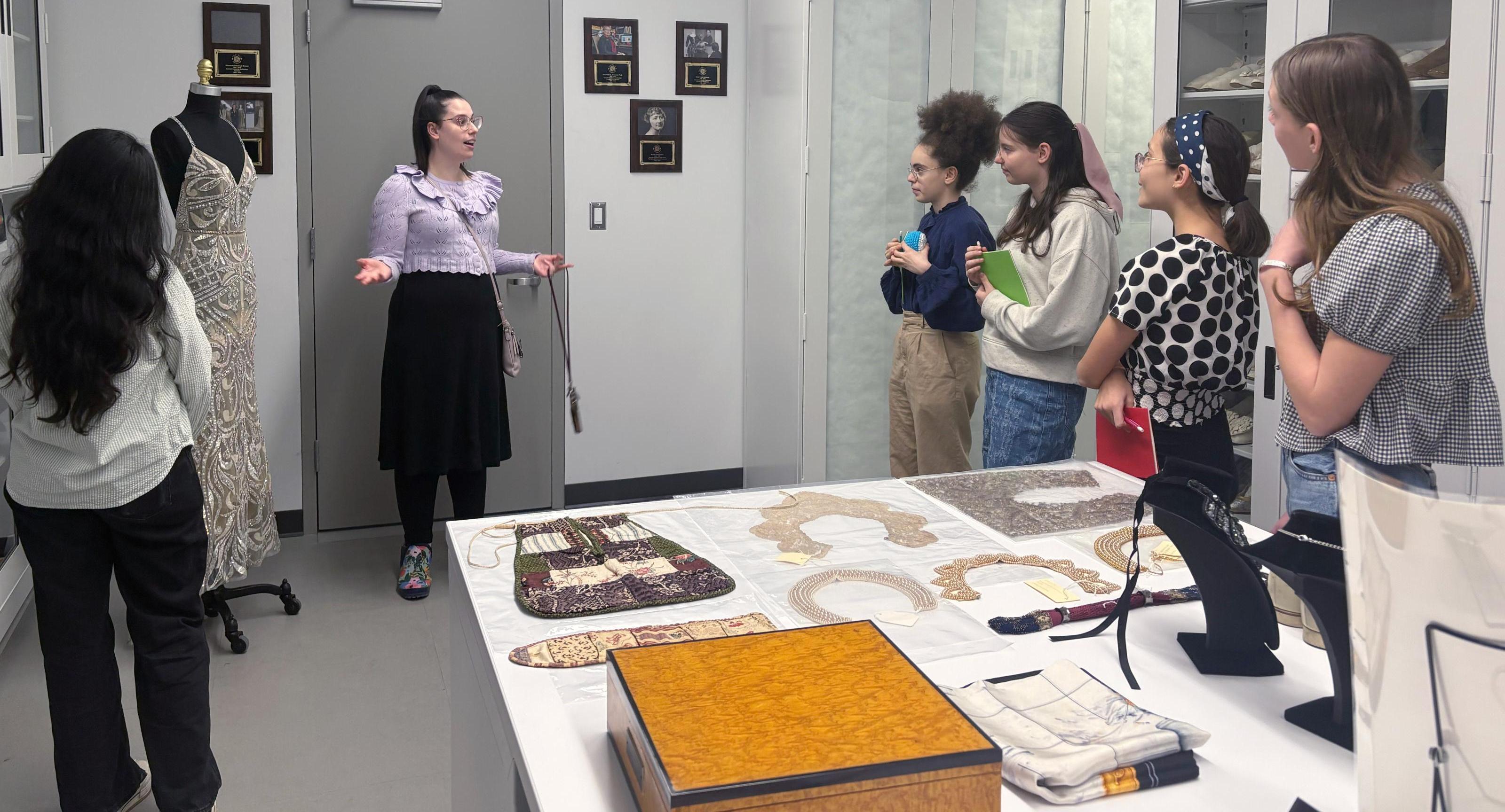 Students receive a guided tour of the Cornell Fashion and Textile Collection