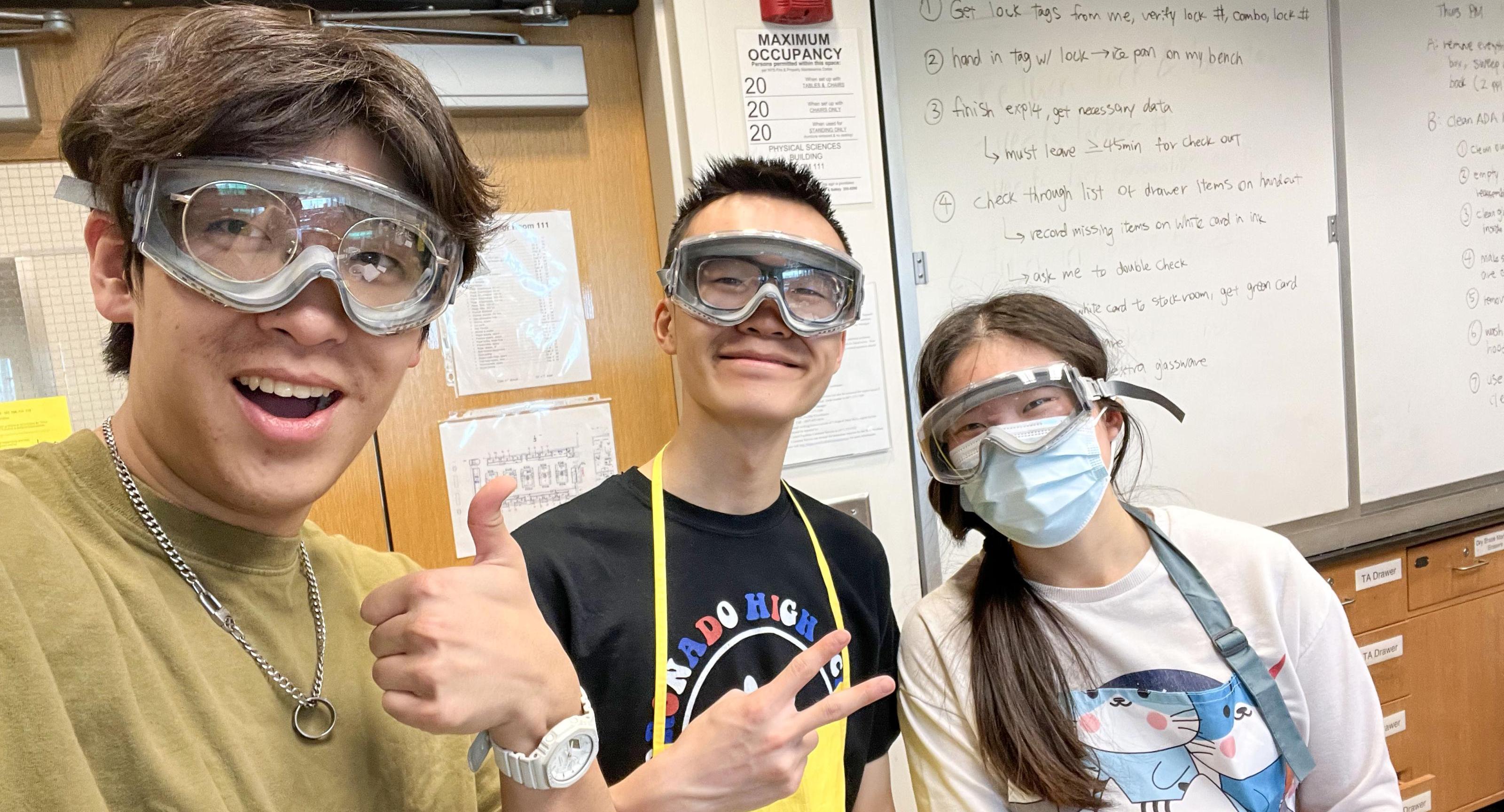 Students in a lab with goggles on. 