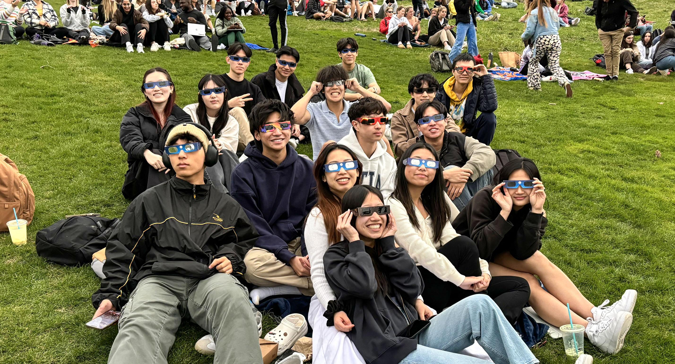 Students watching the solar eclipse with glasses on. 