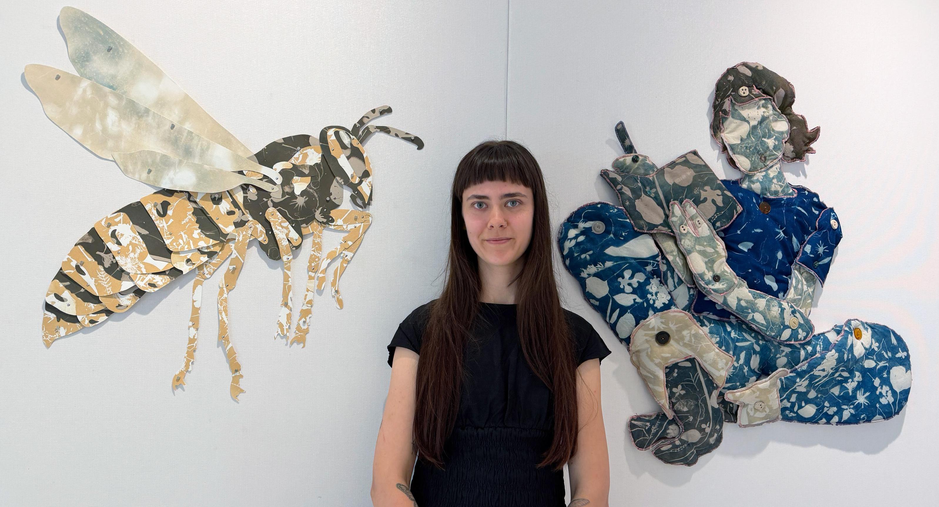 Jaden Demarest portait in front of her art exhibit