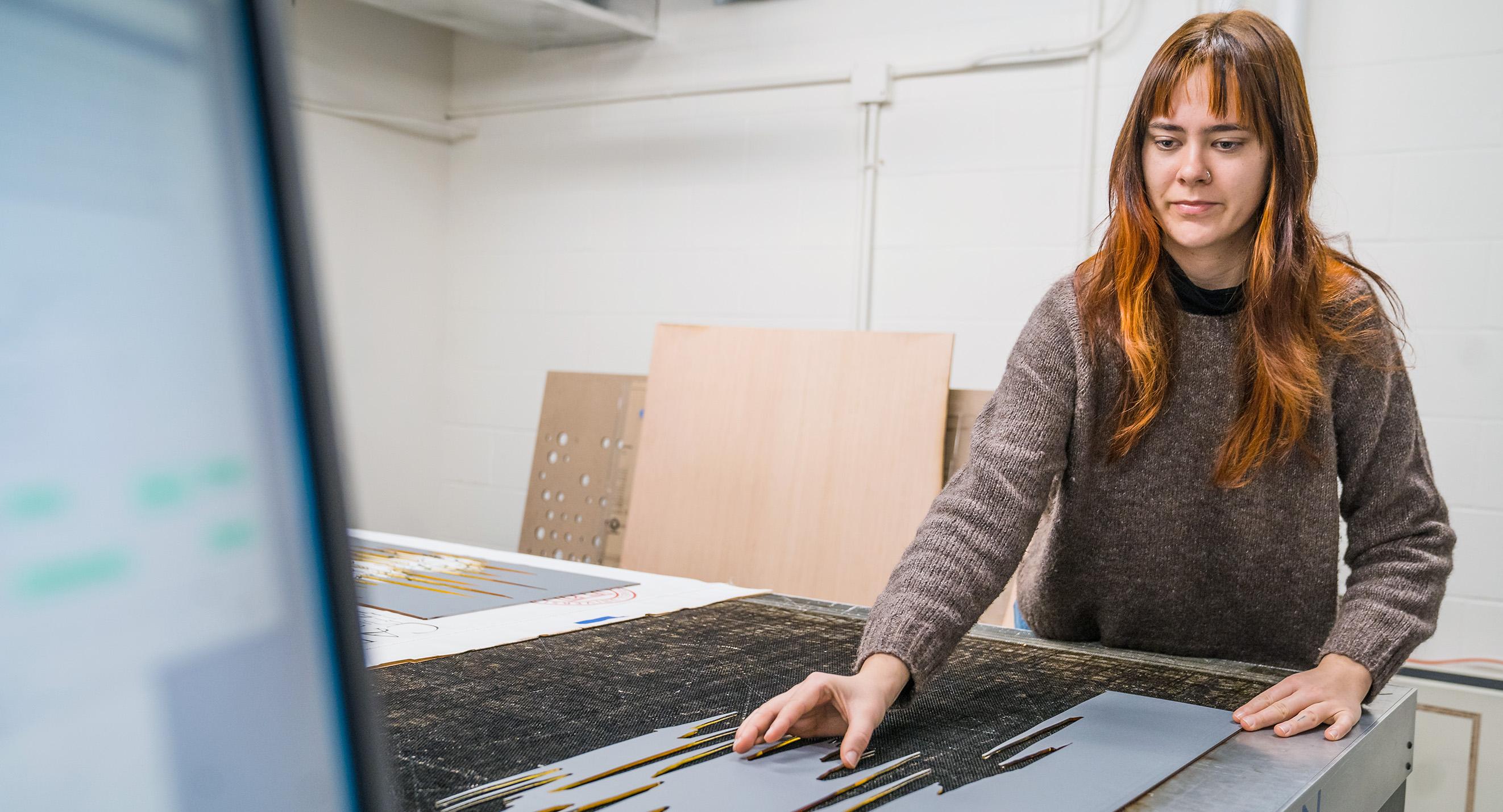 Jaden Demarest operates a laser cutter