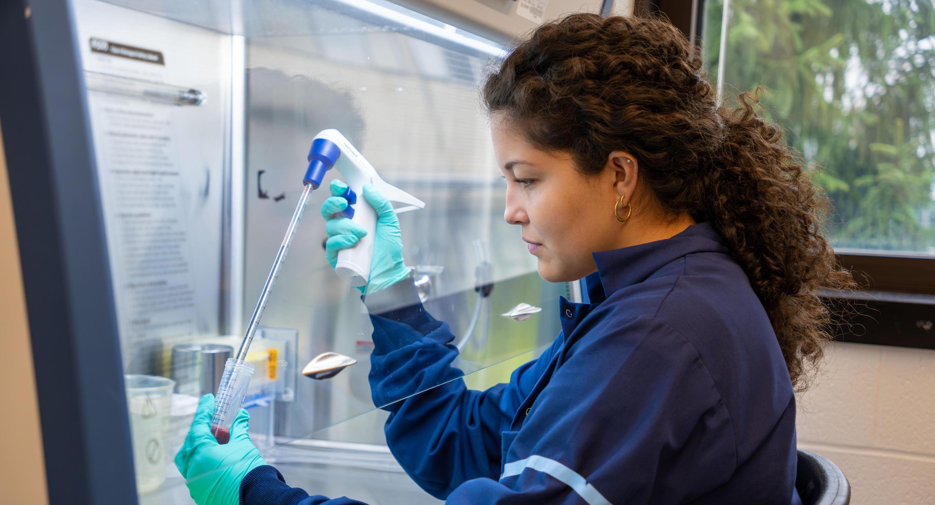 A student pipetting in a lab