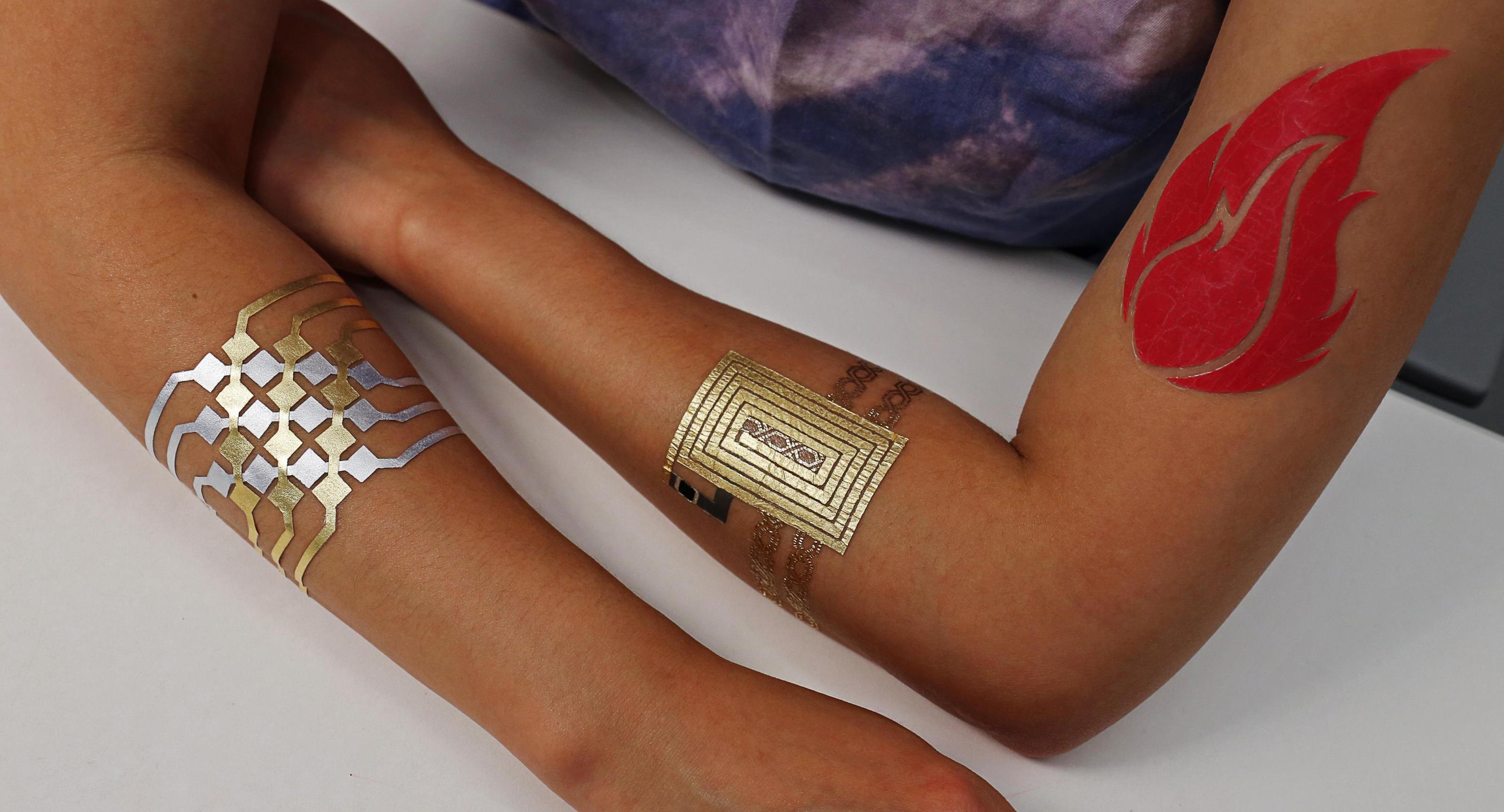 Decorative image: arms with colorful duoskin tattoos