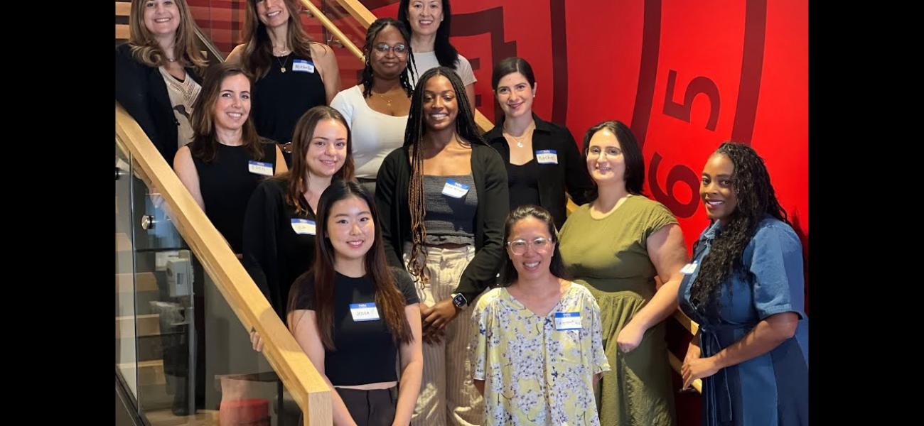 students and faculty on stairs smiling at camera