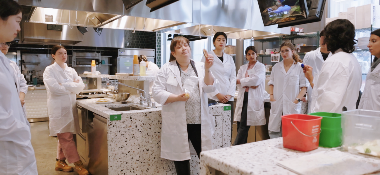 Erin Green showing students a pastry 