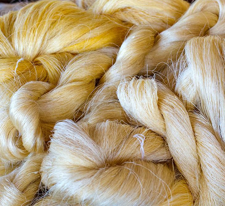 close of of skeins of yellowish white silk yarn