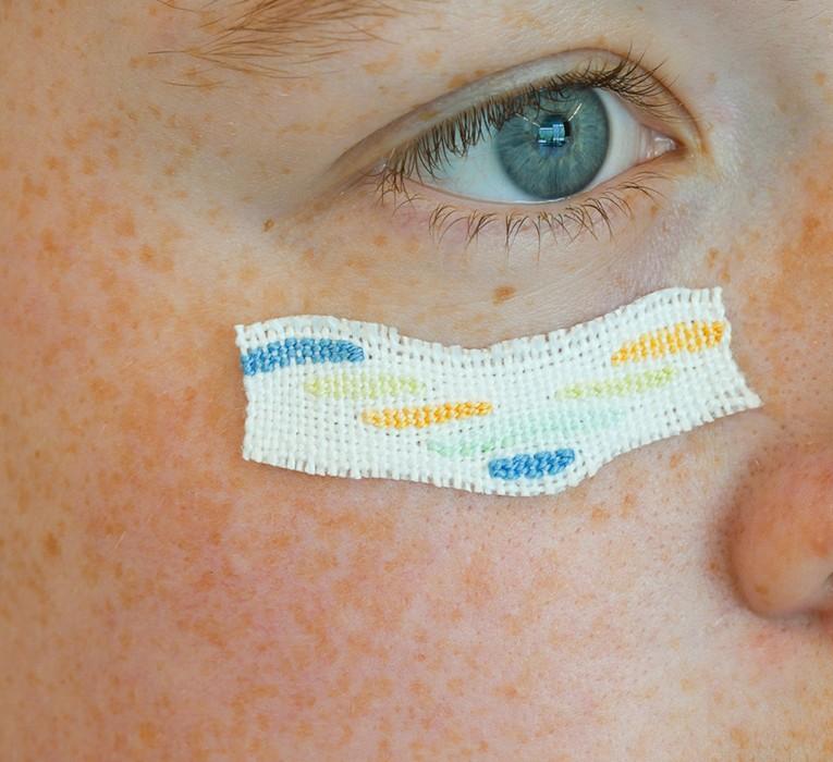 piece of textile attached to a face under the eye