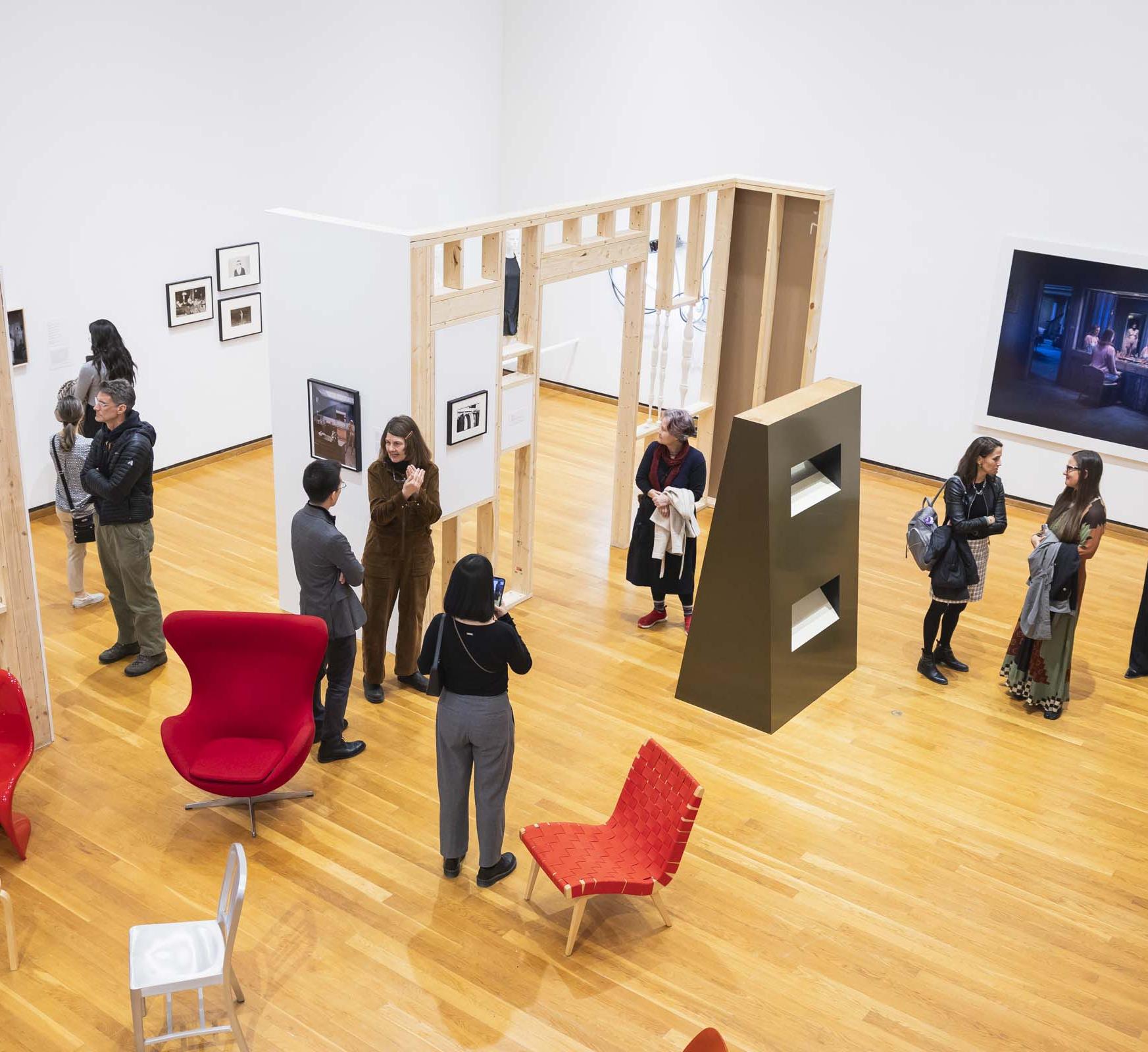 overview of a museum exhibit with people looking at art