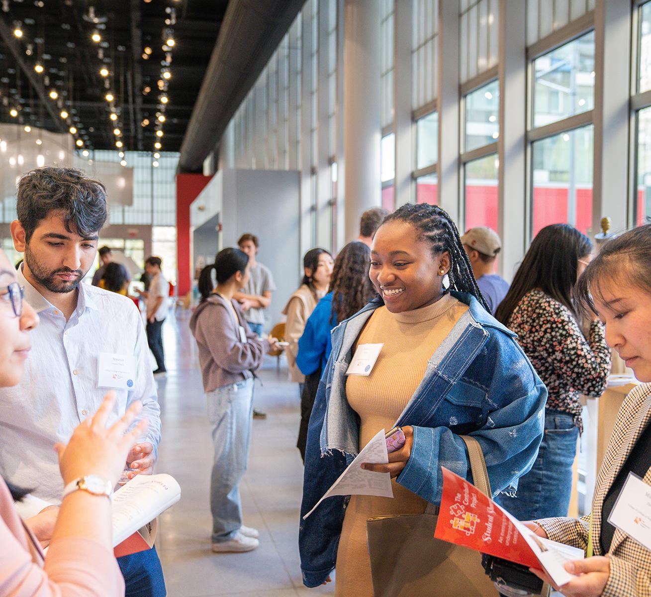 Students converse at the Cornell Human Ecology Contribution Project Student Showcase