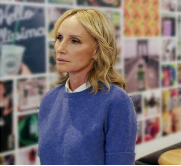 two people standing in front of a board of photos