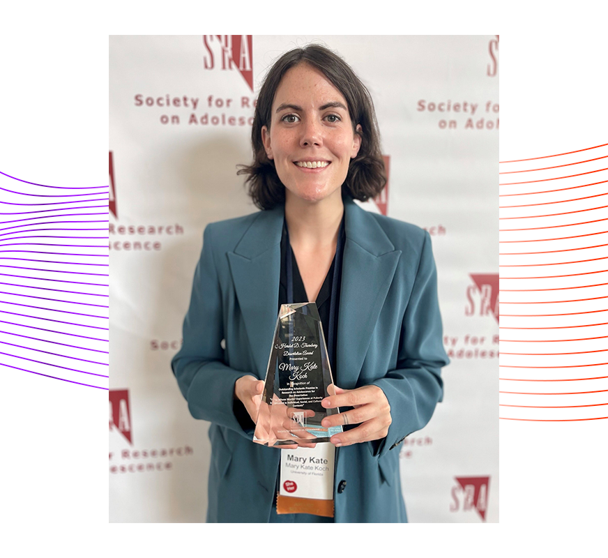 Mary Kate Koch Ph.D. ’22 smiling and holding the Hershel D. Thornburg Dissertation Award