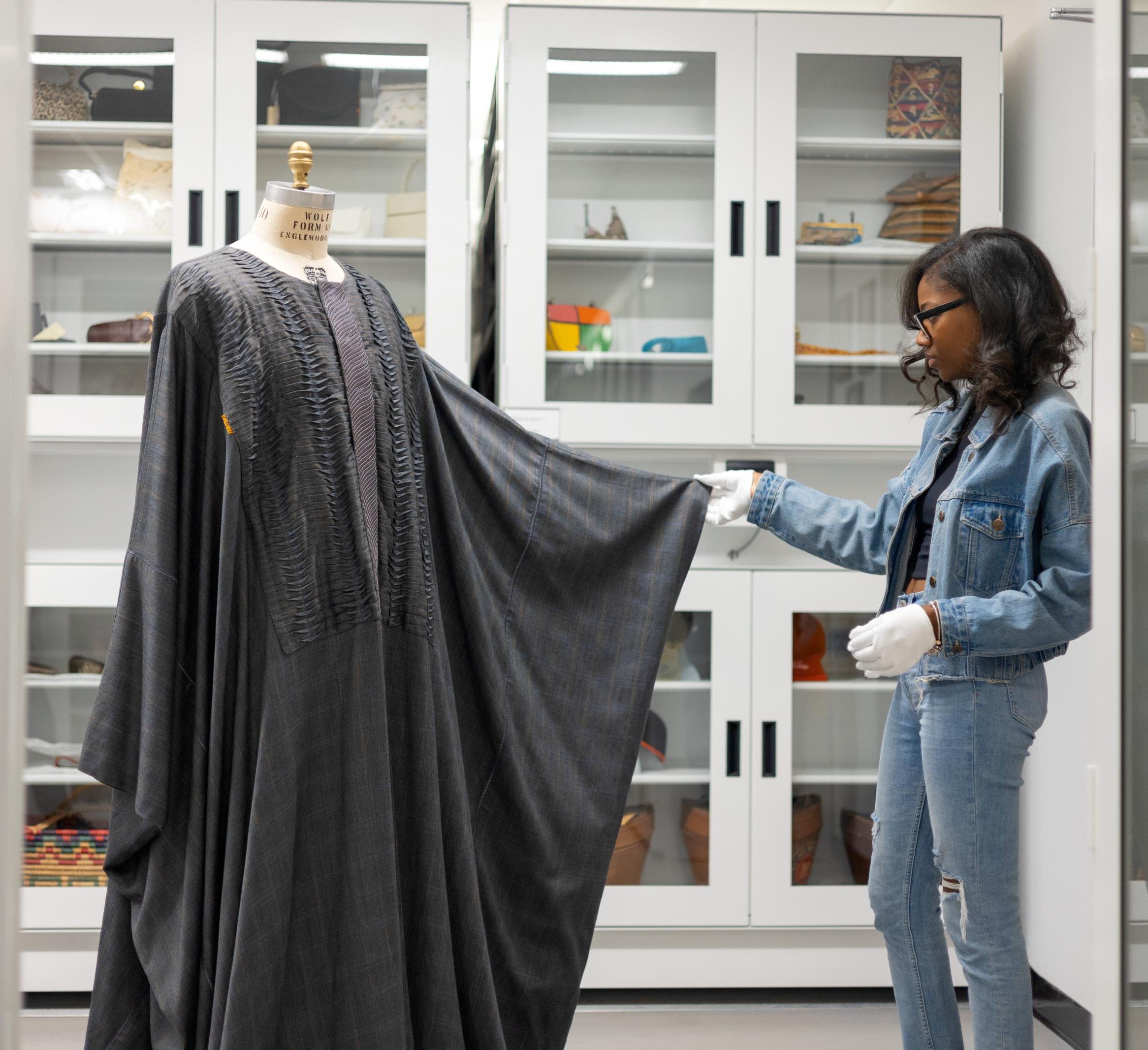Graduate student Dyese Matthews inspects caftan
