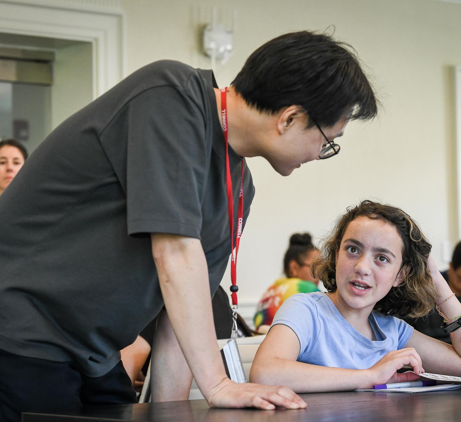 Prof. Jay Yoon speaks to a middle school student during a workshop
