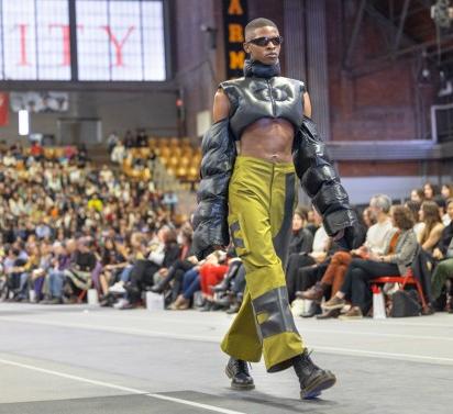 a model walks down the runway in Barton Hall