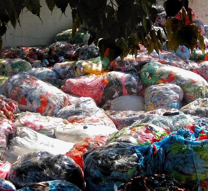 stock image of garbage bags full of textiles