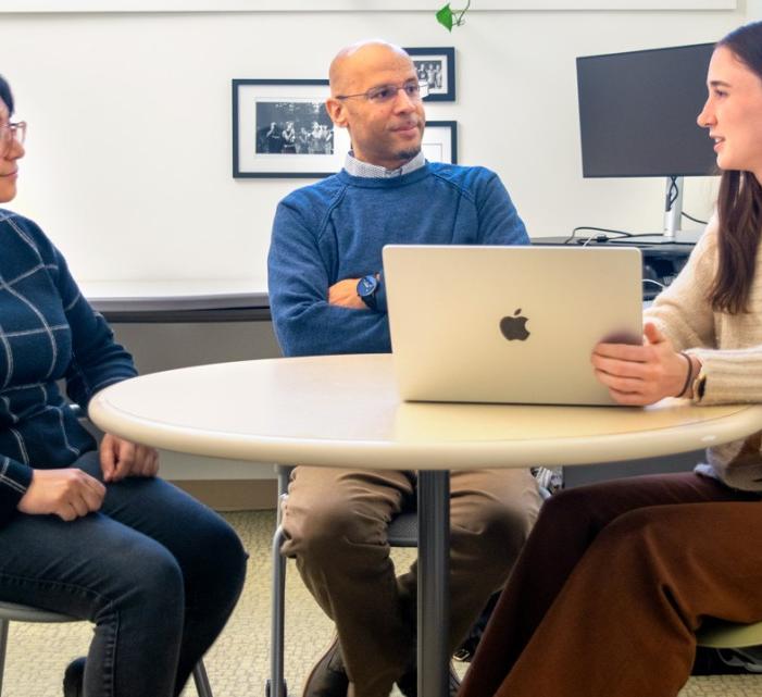 Anthony Burrow, center, the Ferris Family Associate Professor of Life Course Studies in the College of Human Ecology, discusses research with Lynandrea Mejia, left, of the Bronfenbrenner Center for Translational Research, and Ravenel Davis, a doctoral student.
