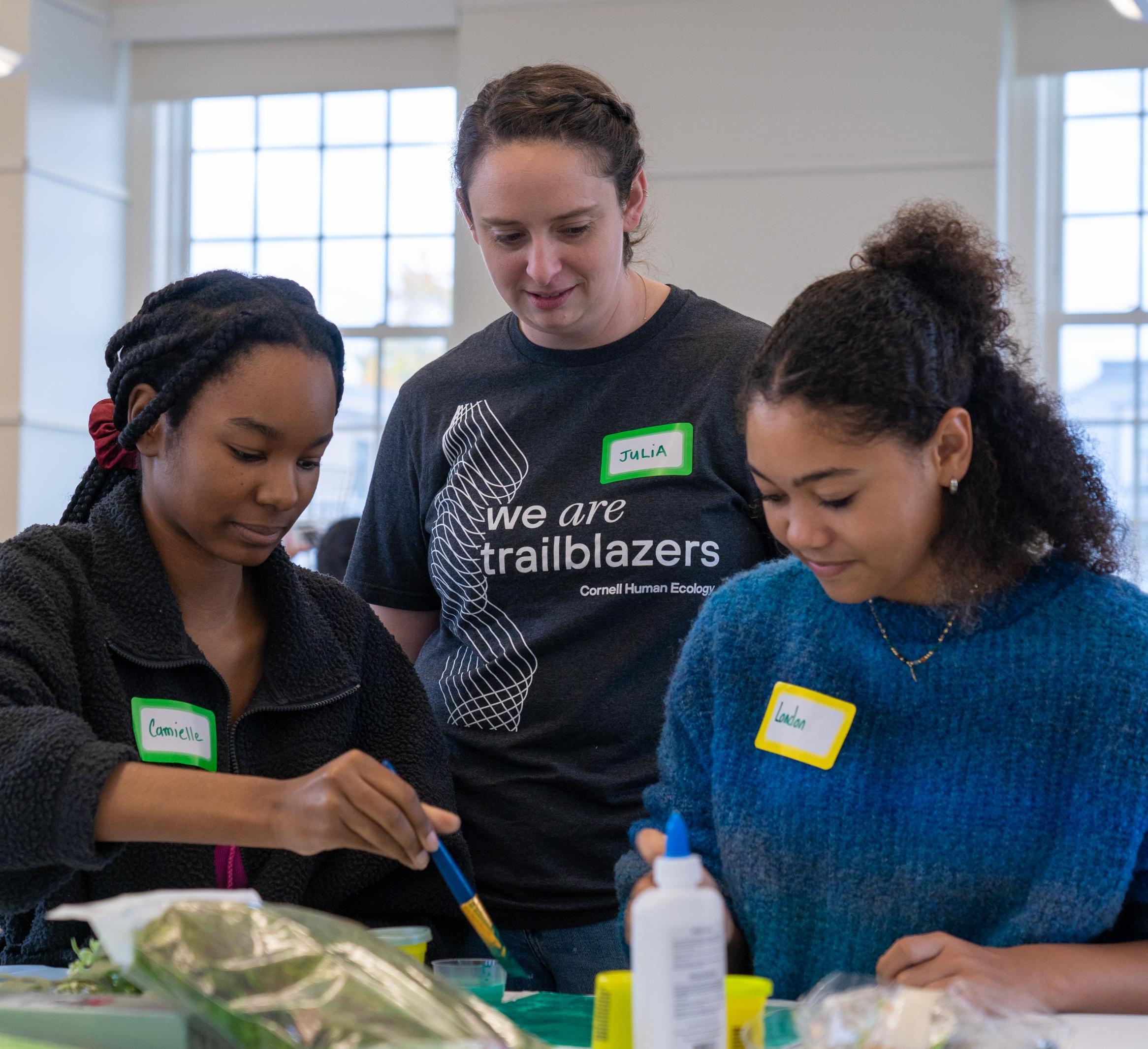 Two youth create their vision for an ideal outdoor space as Julia Jaffe looks on
