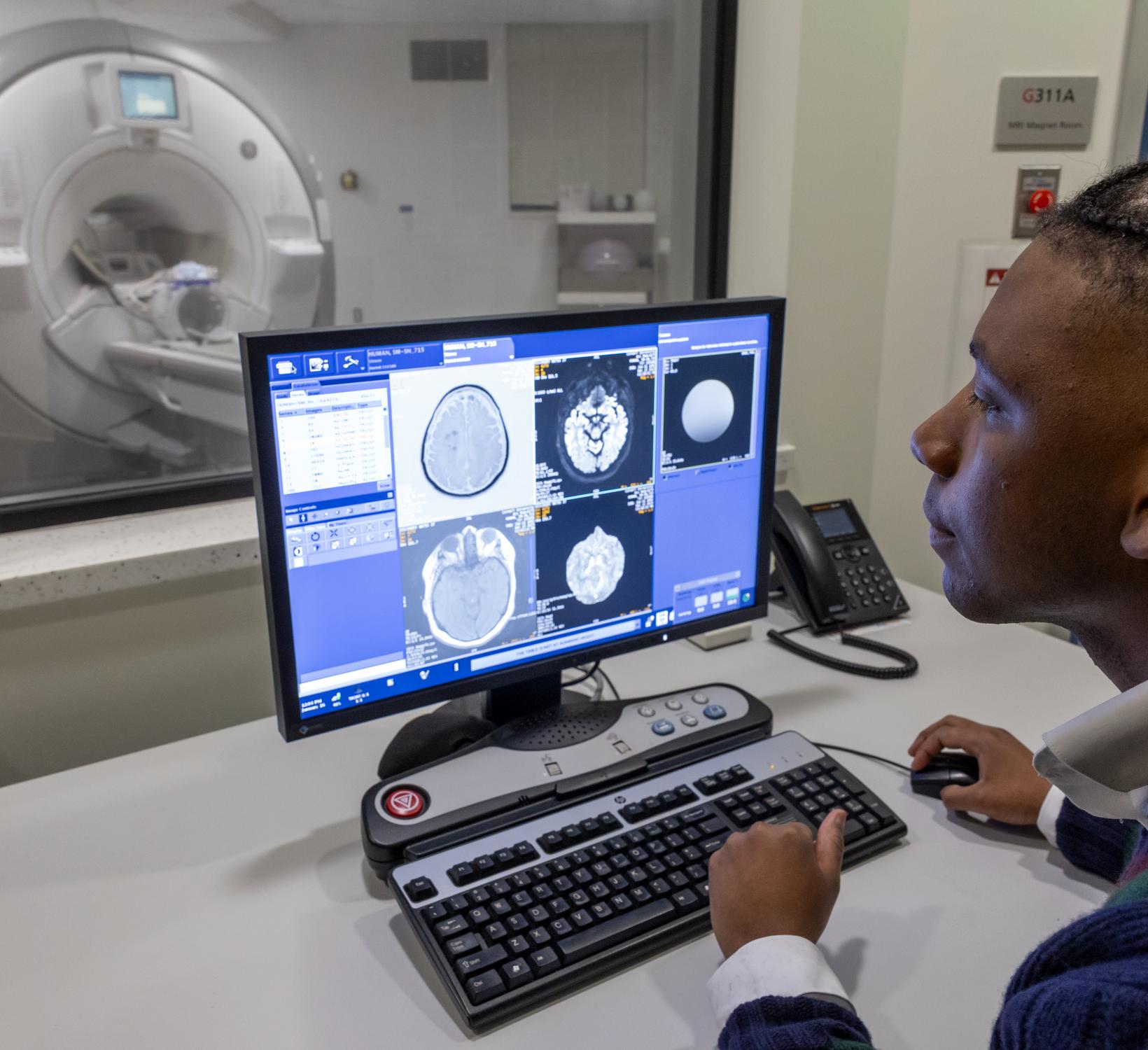 Senegal Mabry looks at brain MRIs