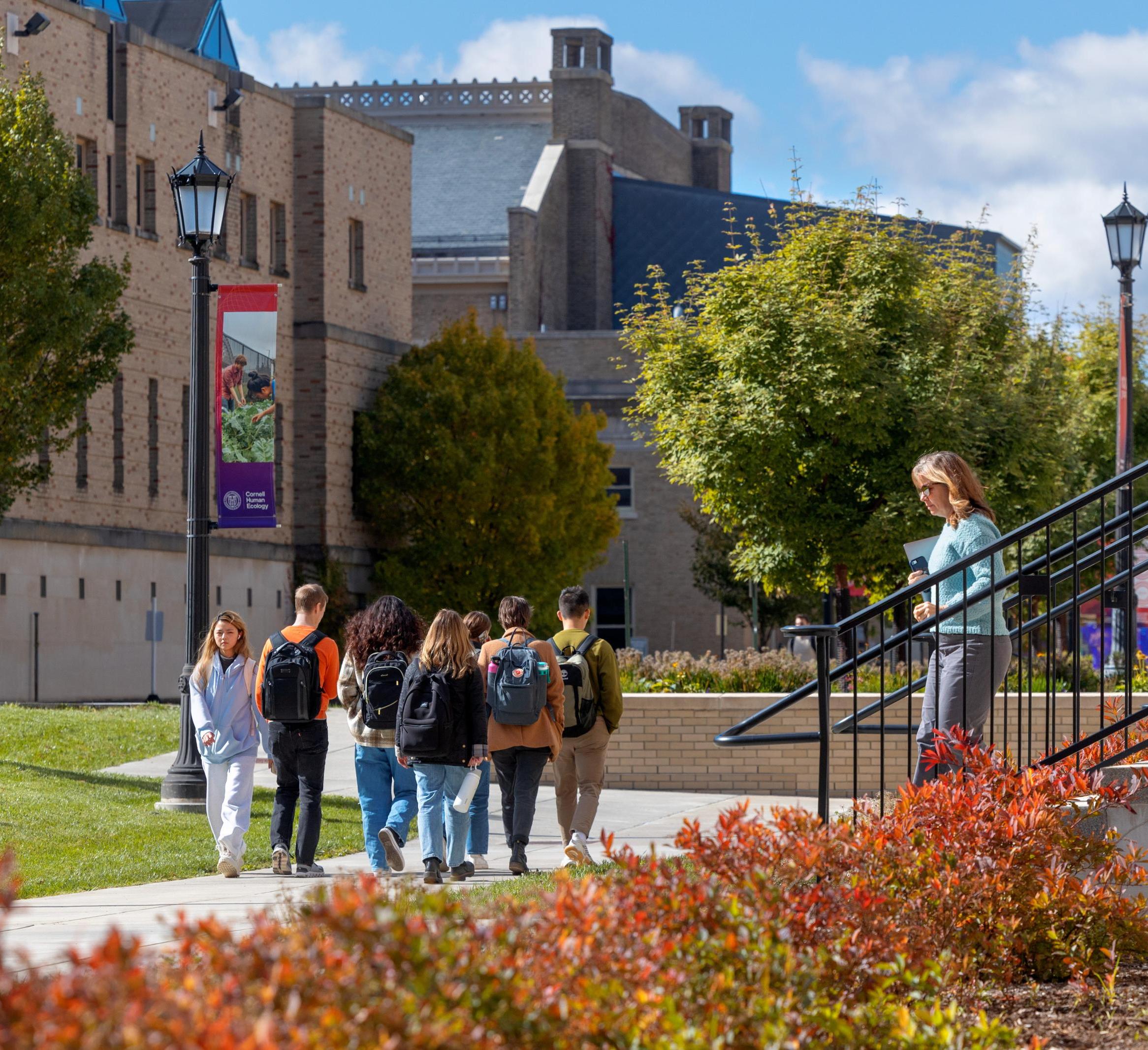 students walk past MVR on a fall day