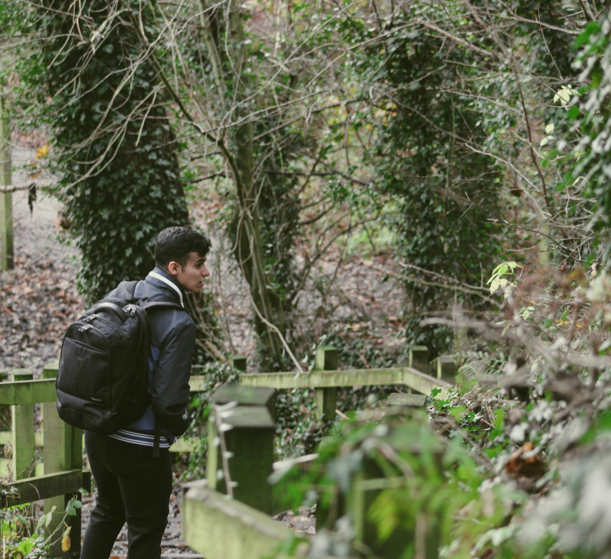 man walks outside in the woods 