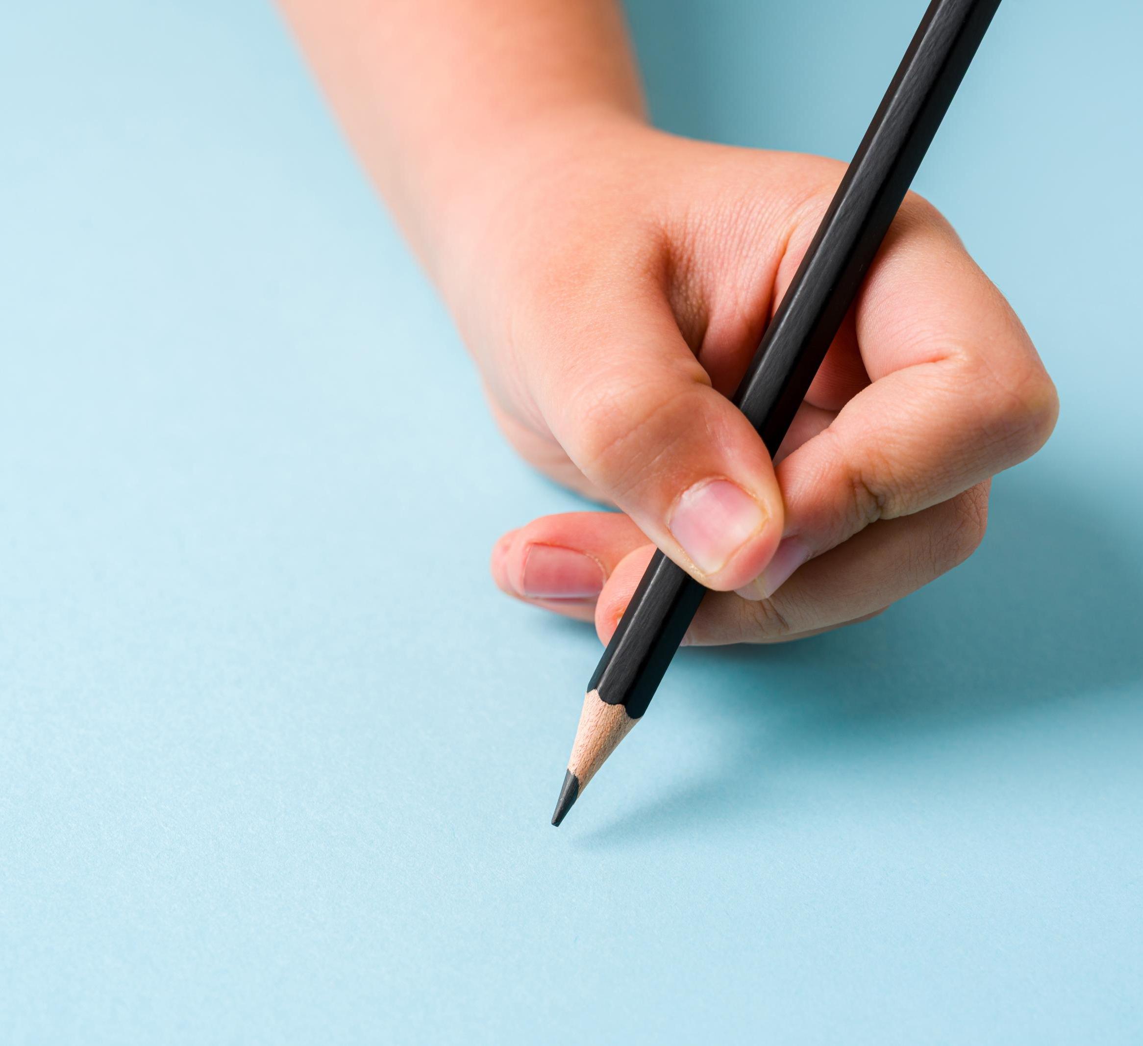 Left hand holding a pencil 