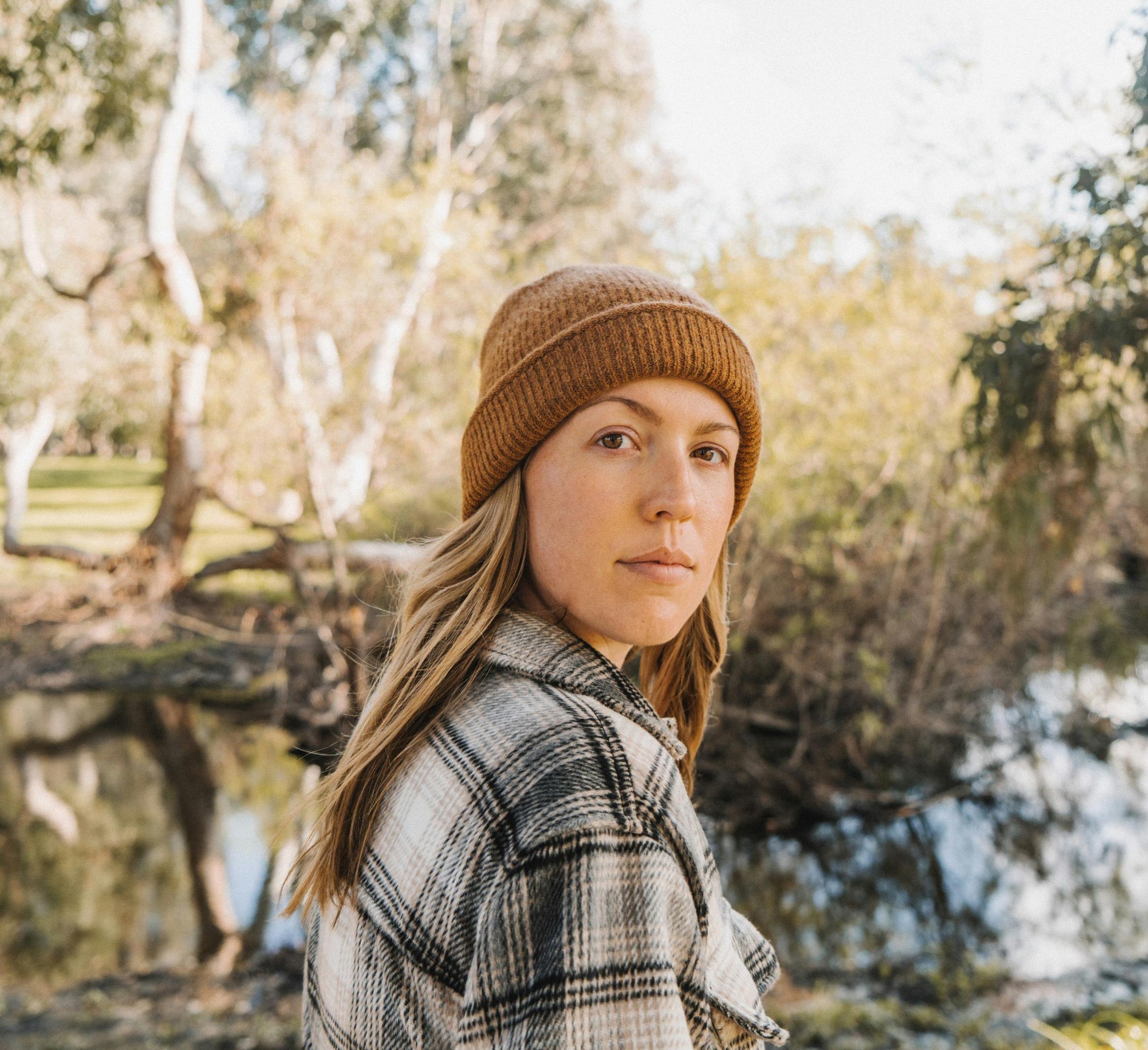 Serious person looking at camera with a hat on