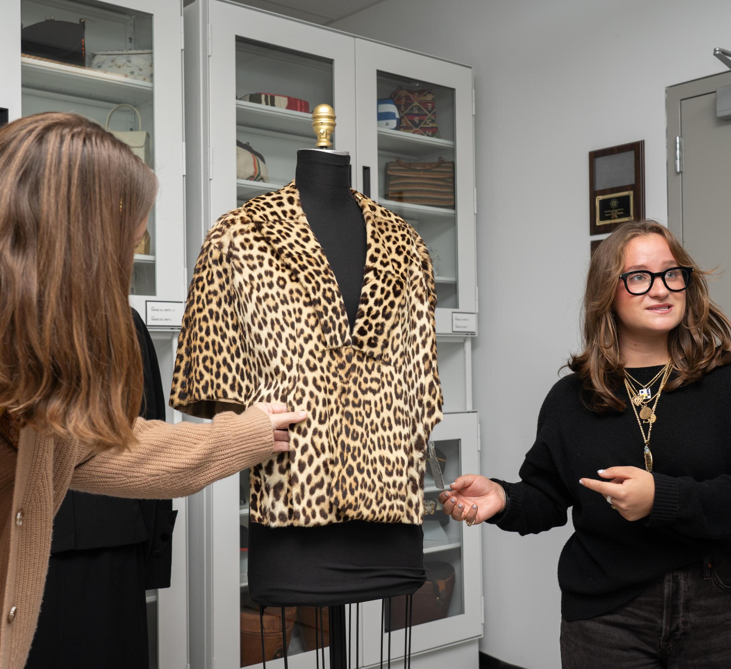 Sophia Peck points to a leopard print jacket