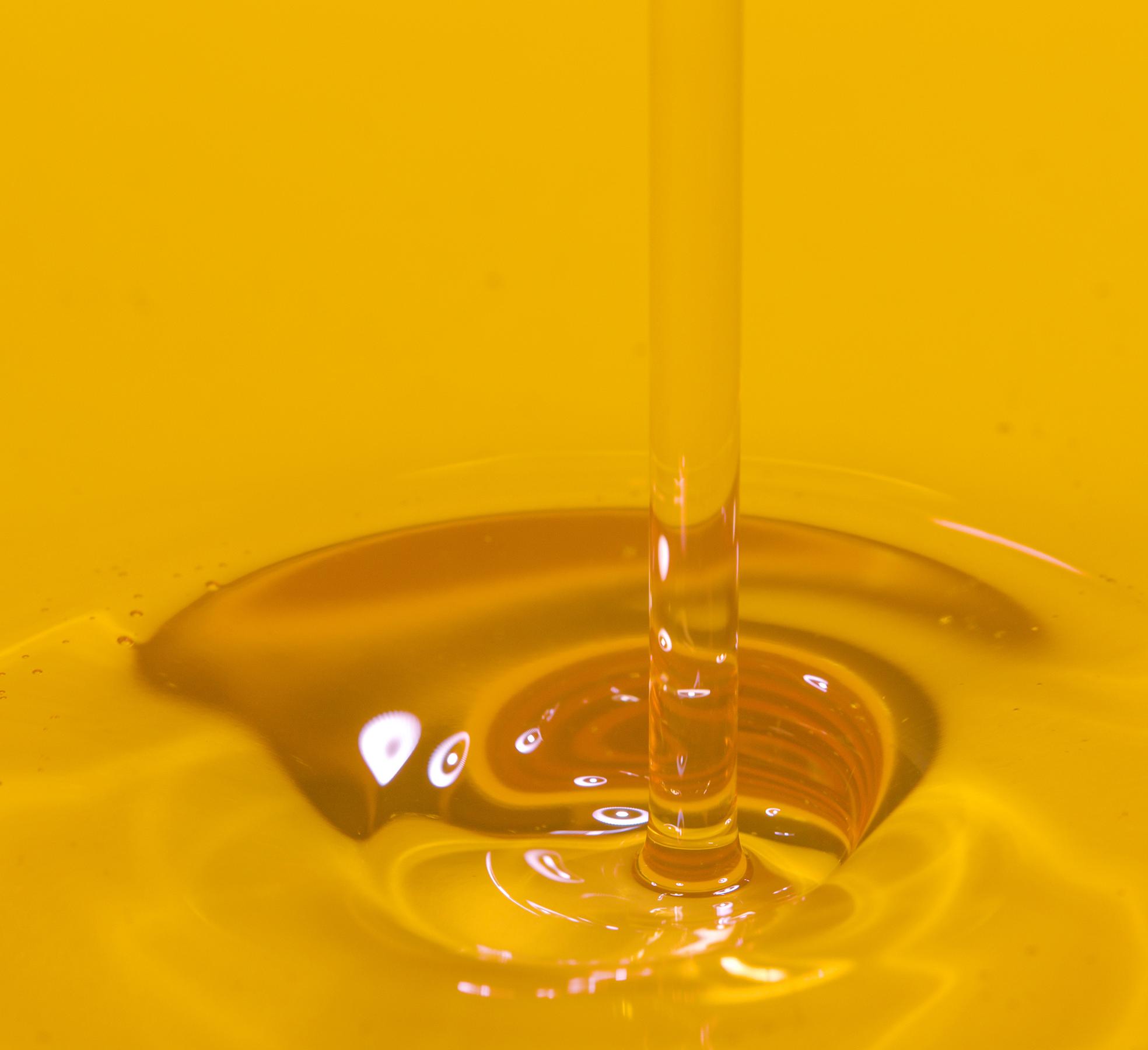 close up of cooking oil being poured