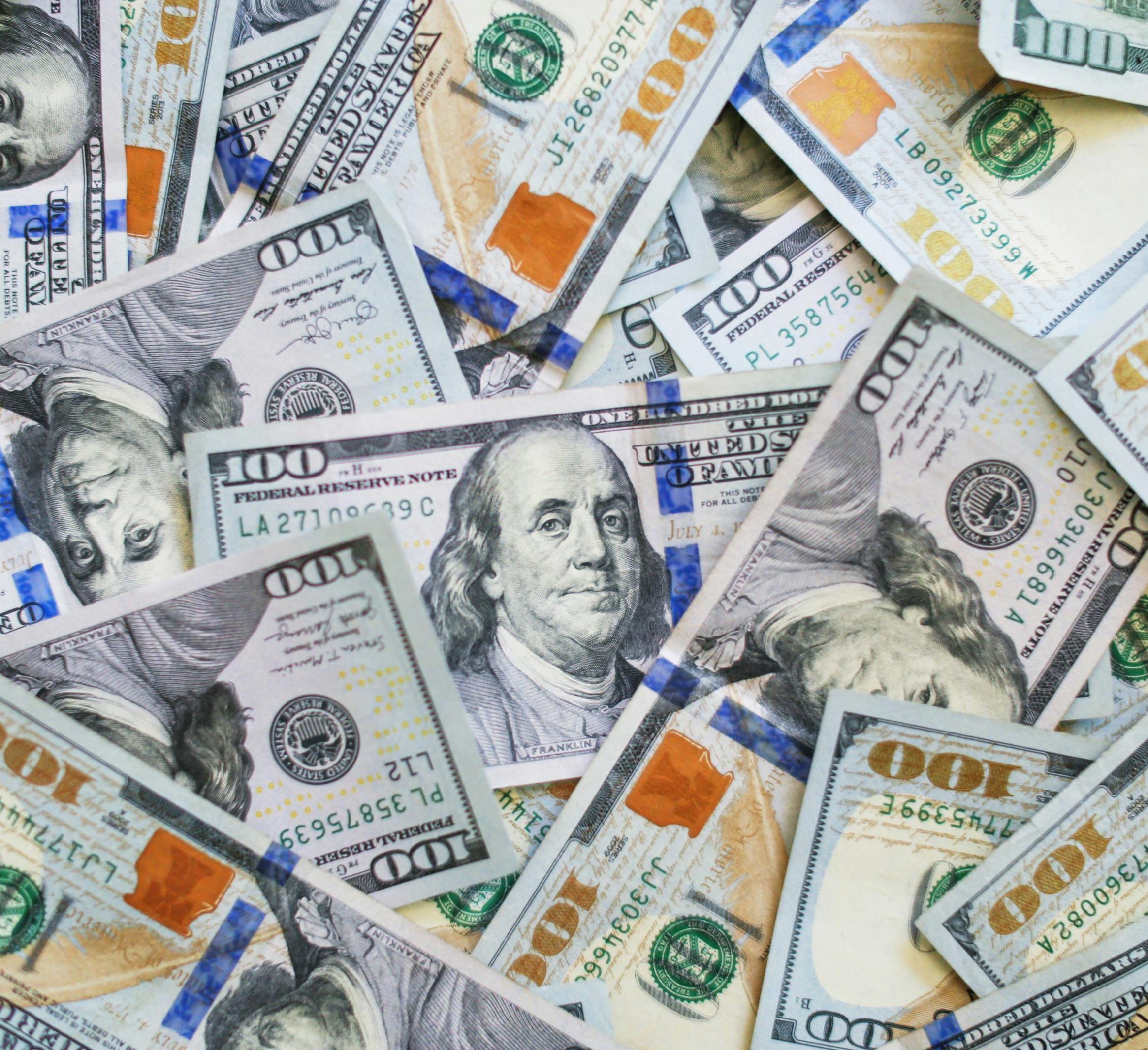 US $100 bills in different orientations 