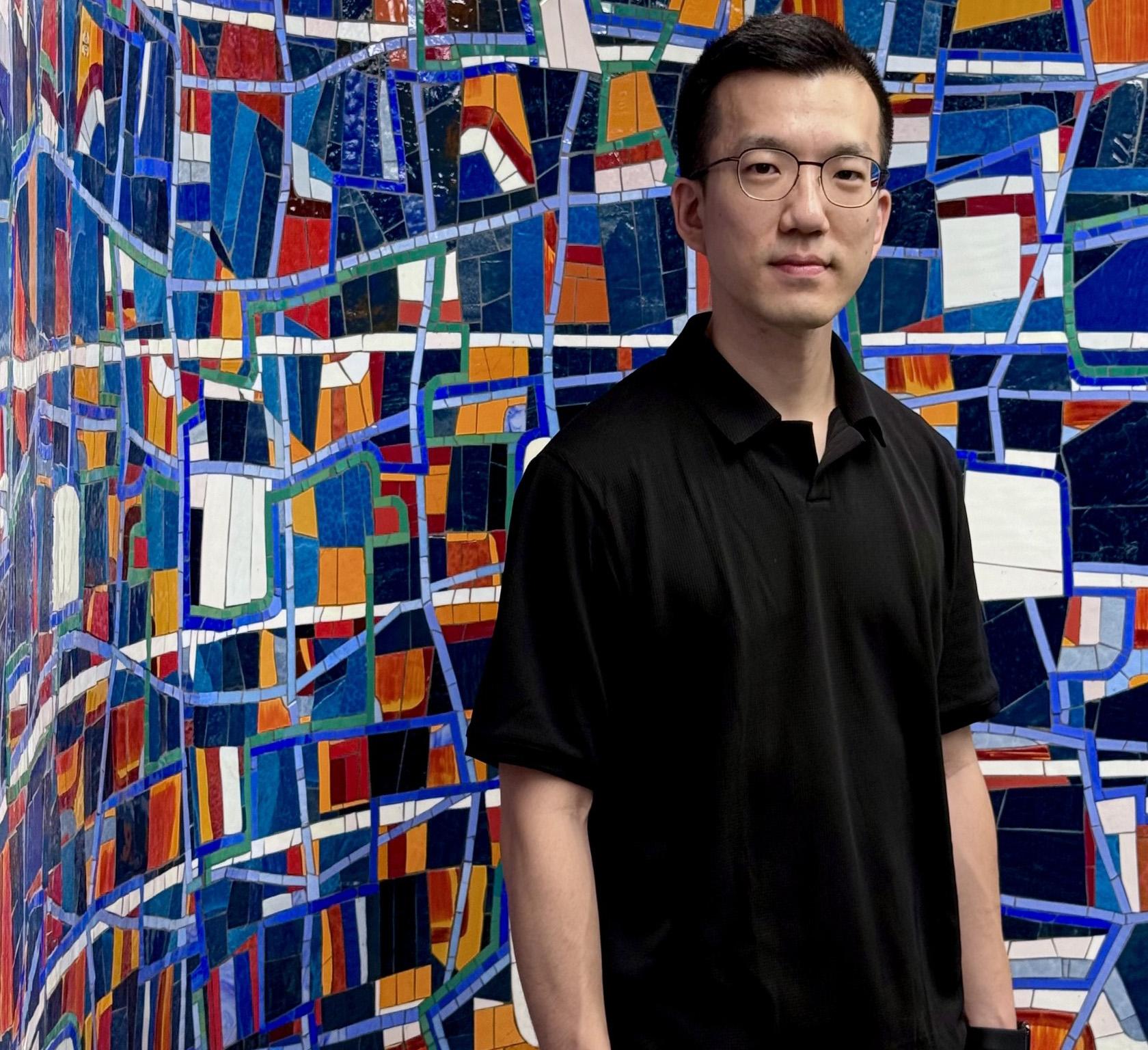 Eddy Man Kim in front of Mosaic 