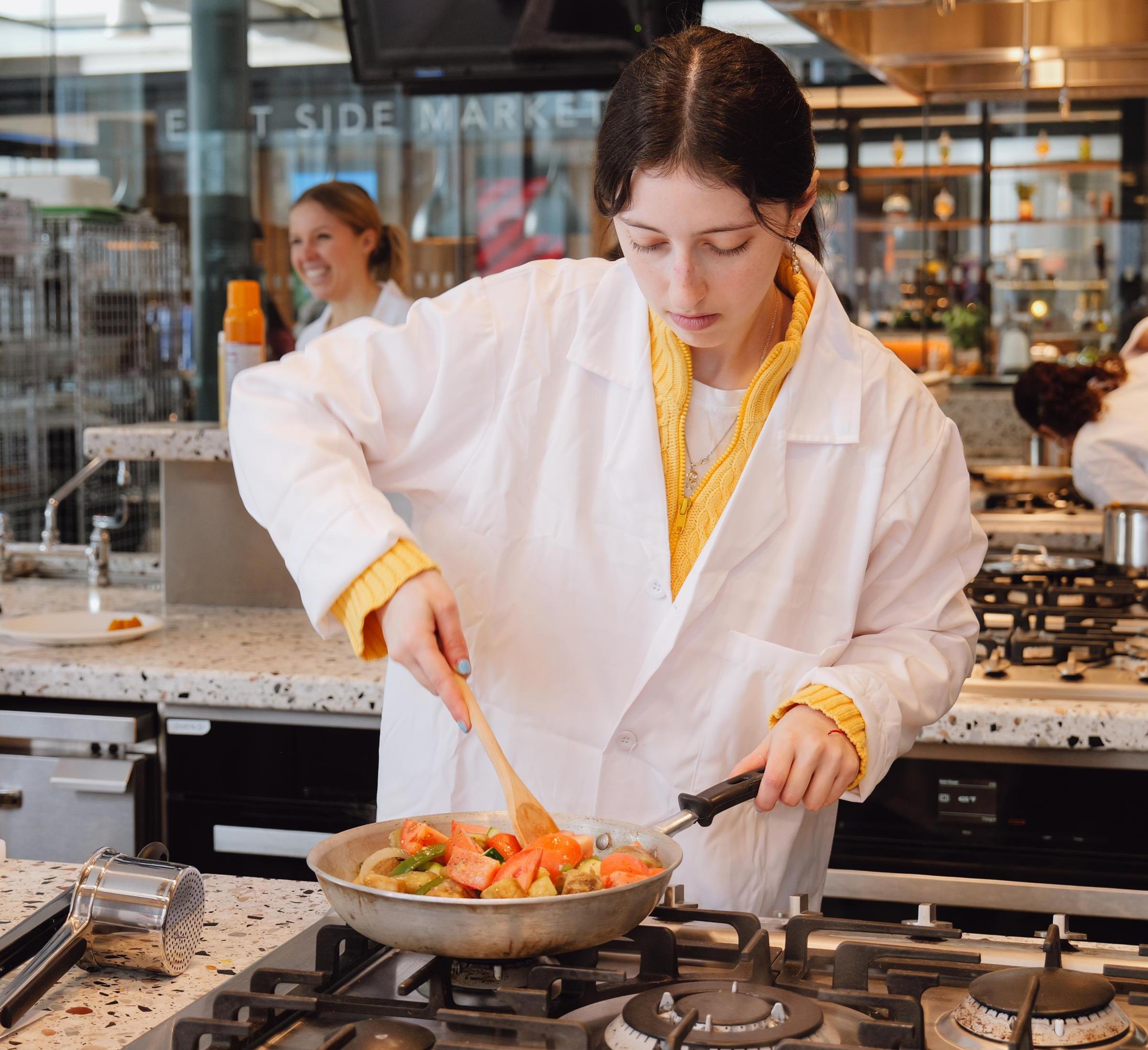 A student cooking in the Discovery Kitchen