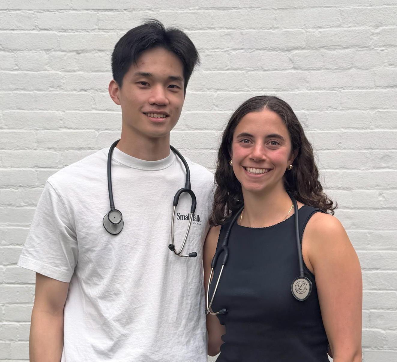Two students post together with stethoscopes around their necks
