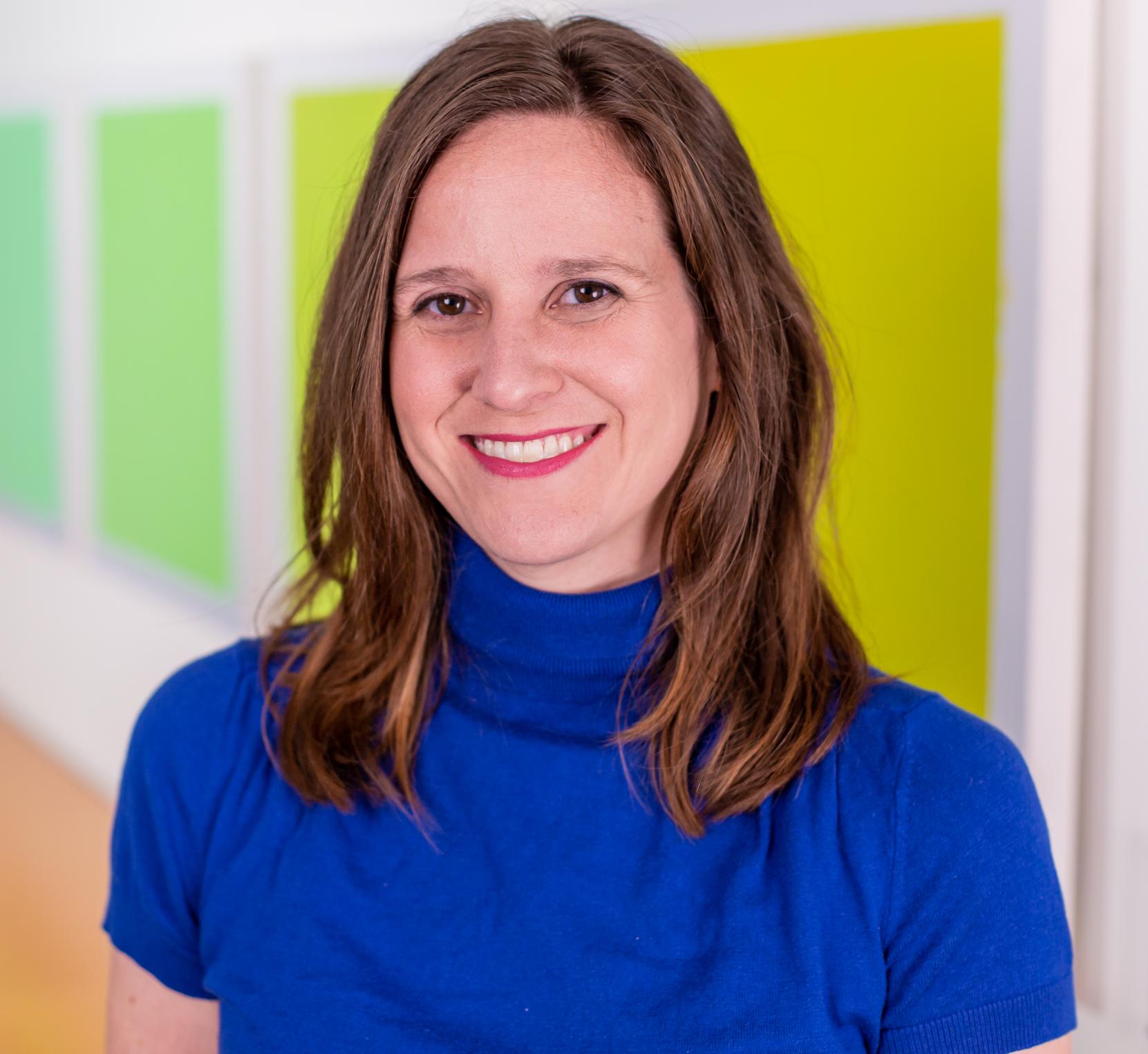 woman in a bright blue top and red lipstick