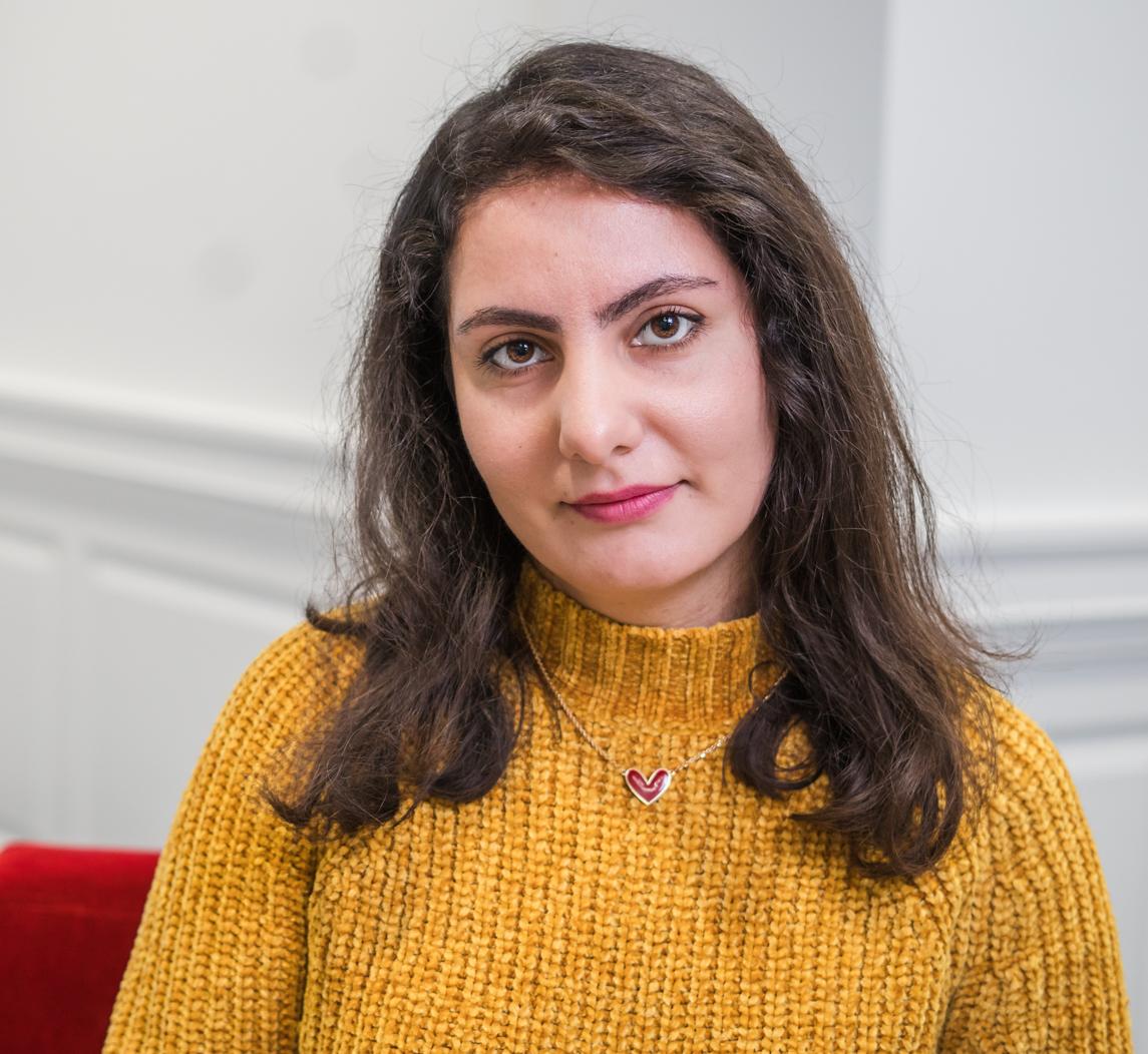 portrait of a woman in a yellow sweater