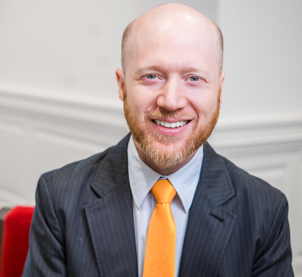 man in a suit with a yellow tie