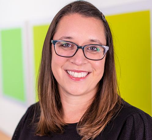 woman in front of a series of green squares