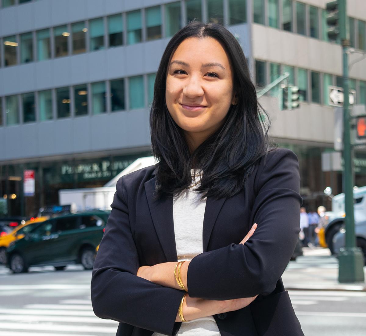 Navika Gangrade stands in front of a building in New York City