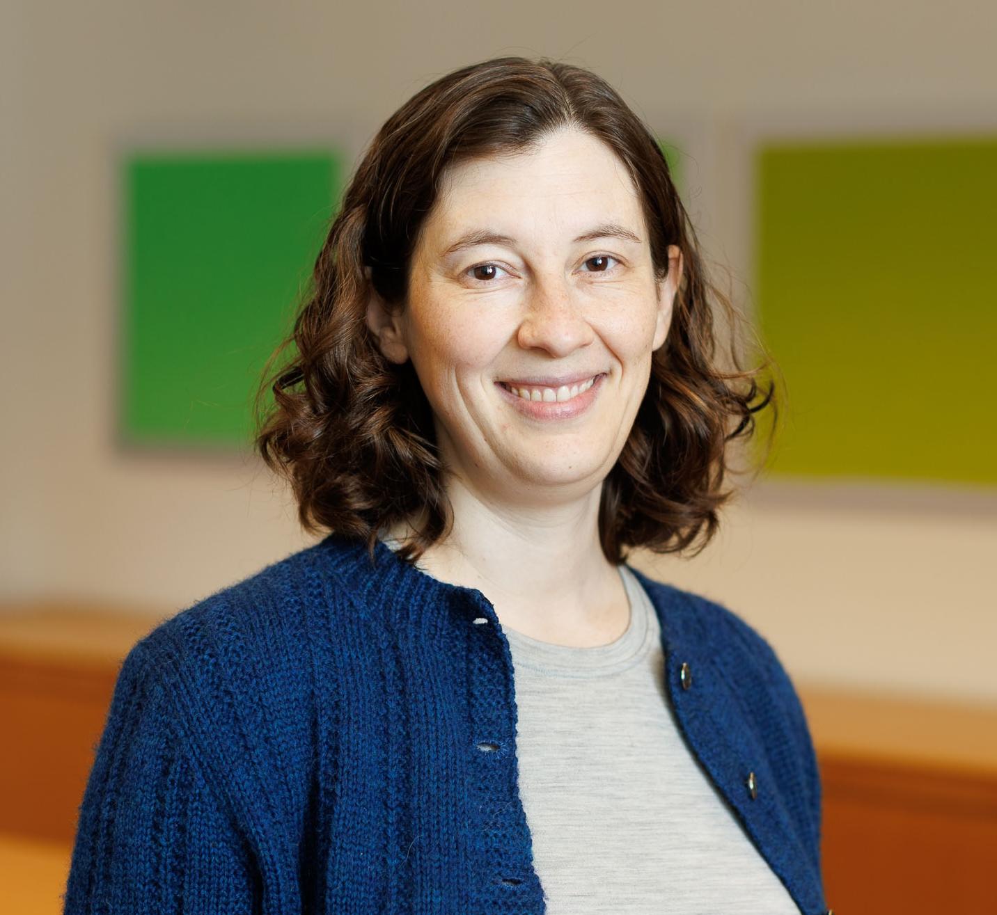 Portrait of Elizabeth Riley wearing a blue sweater