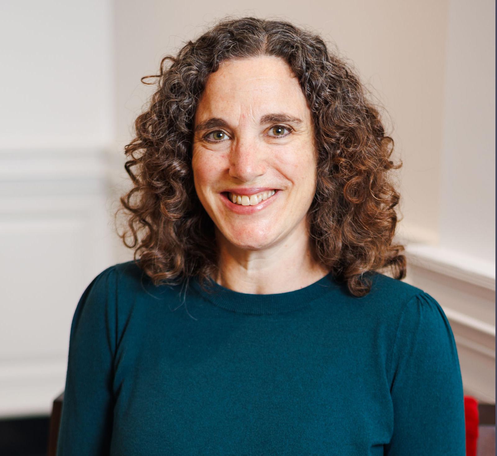Portrait of Sharon Kaplan wearing a teal sweater