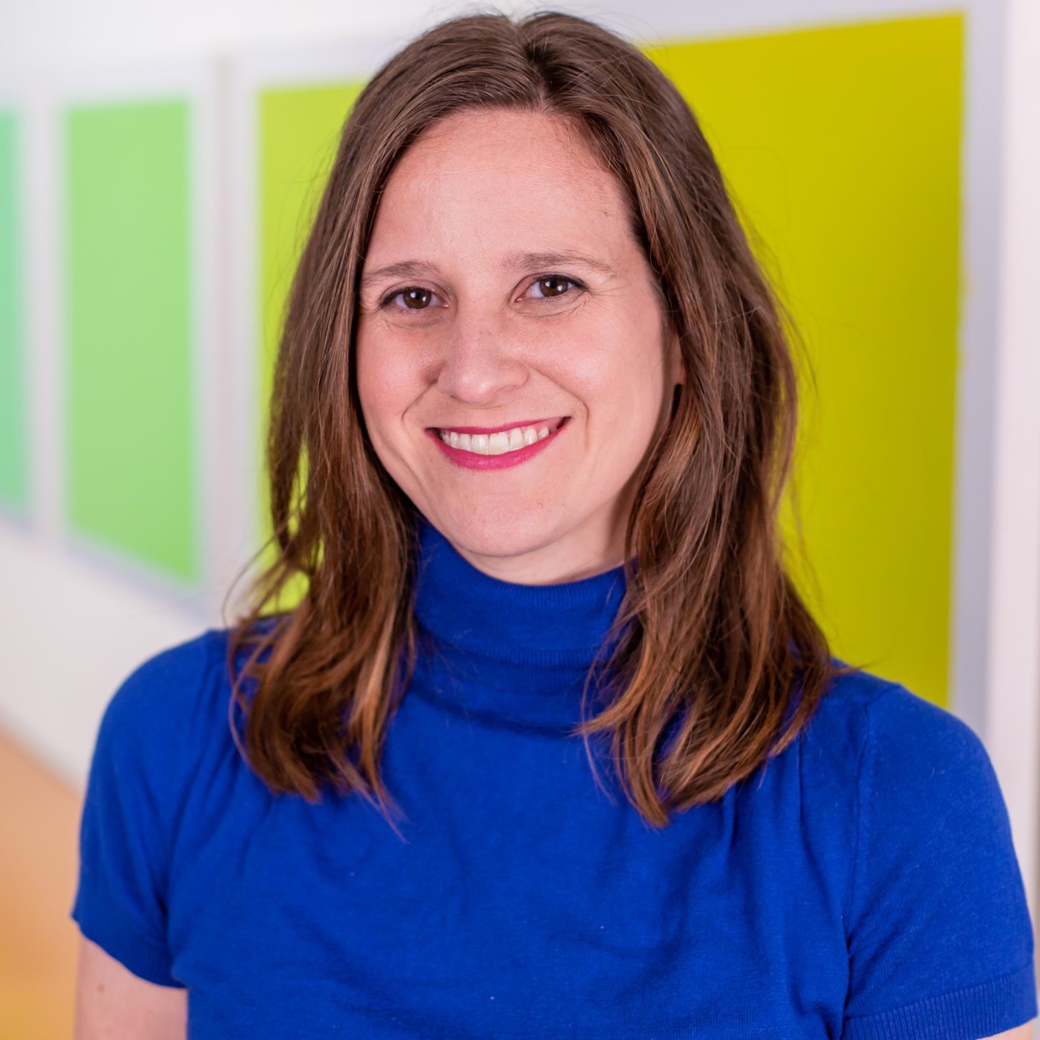 woman in a bright blue top and red lipstick