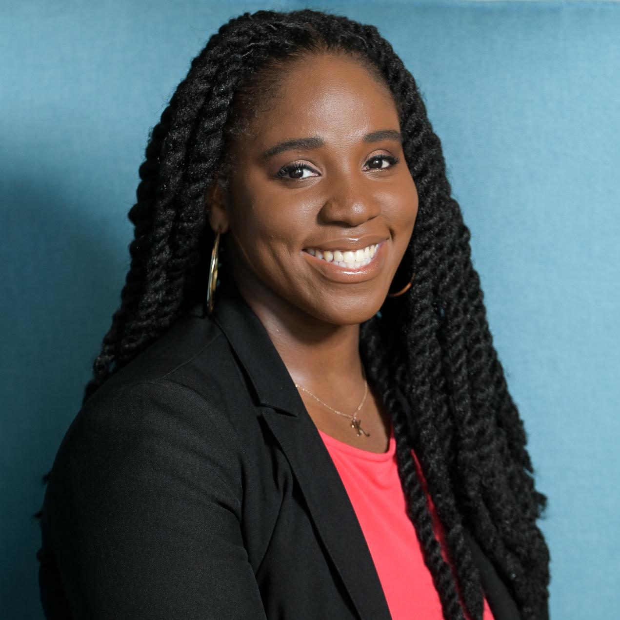 portrait of a woman sitting in a high backed light blue chair
