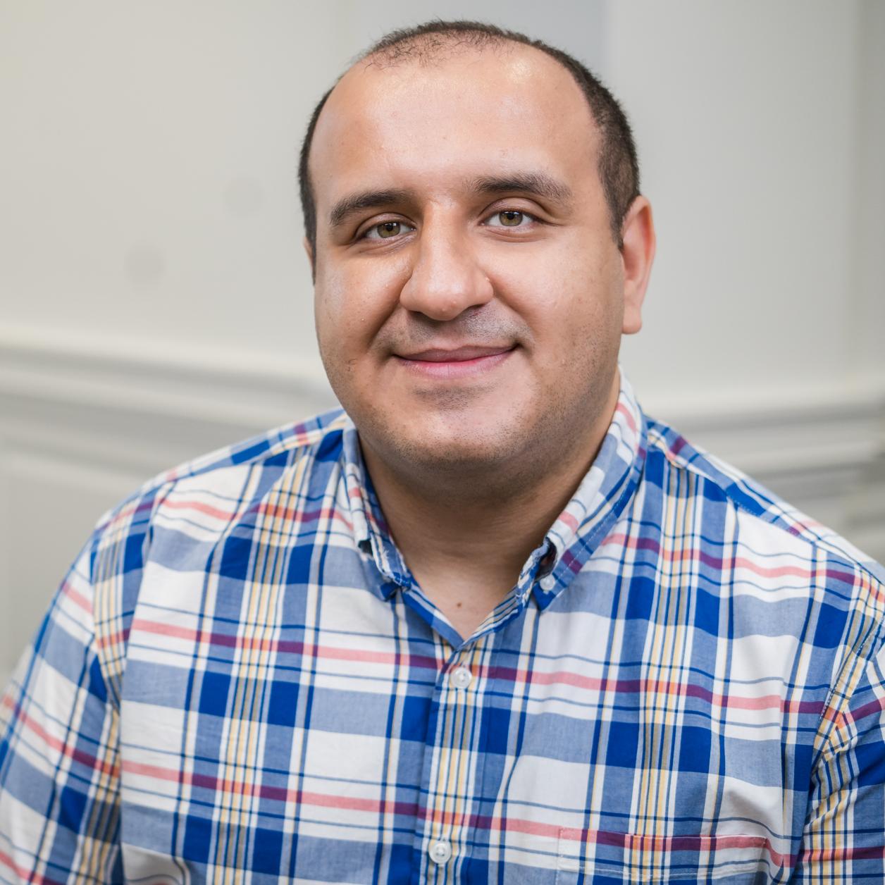 portrait of a man in a blue plaid shirt