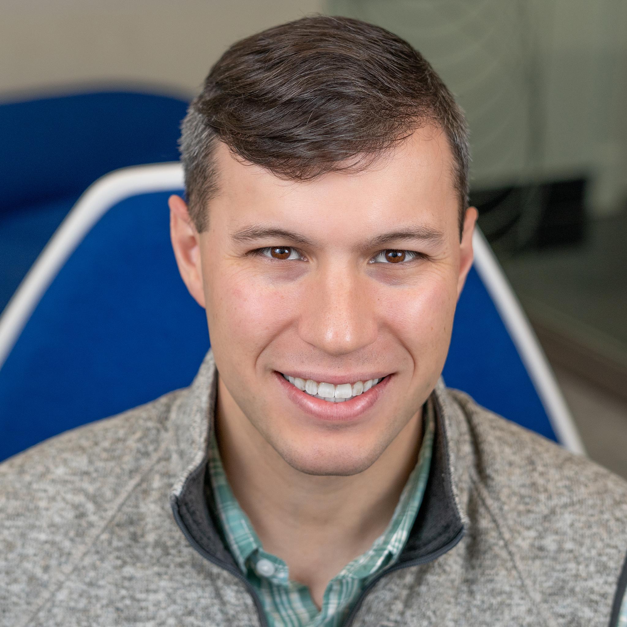 man sitting in a bright blue chair