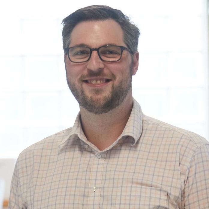 man wearing glasses and a button down shirt