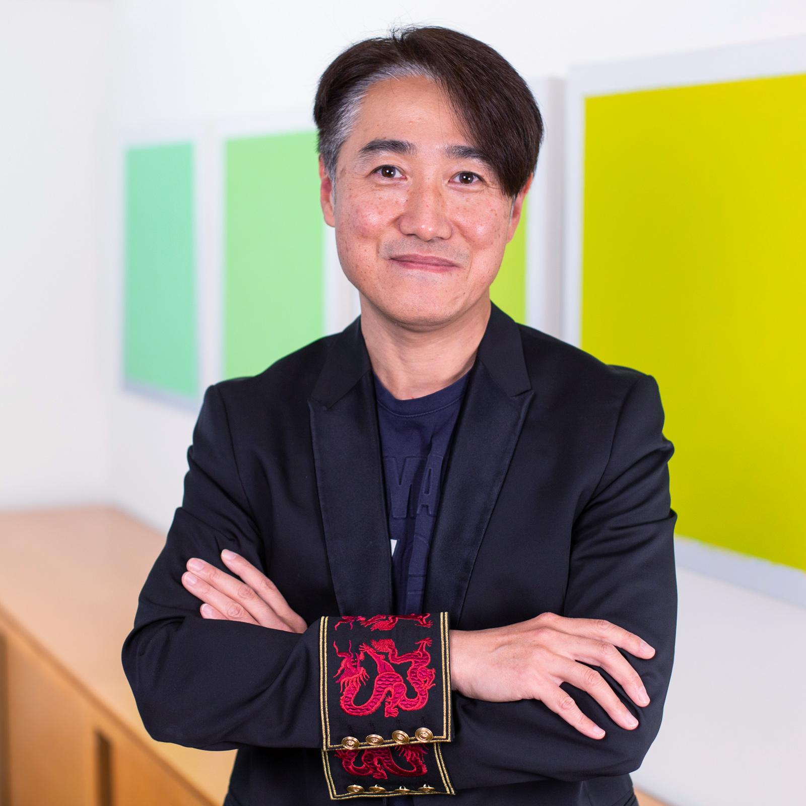 portrait of a man wearing a blazer with bright red embroidered cuffs