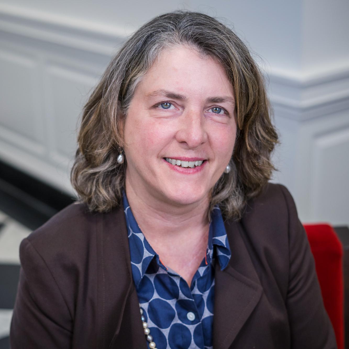 portrait of a woman sitting in a red chair