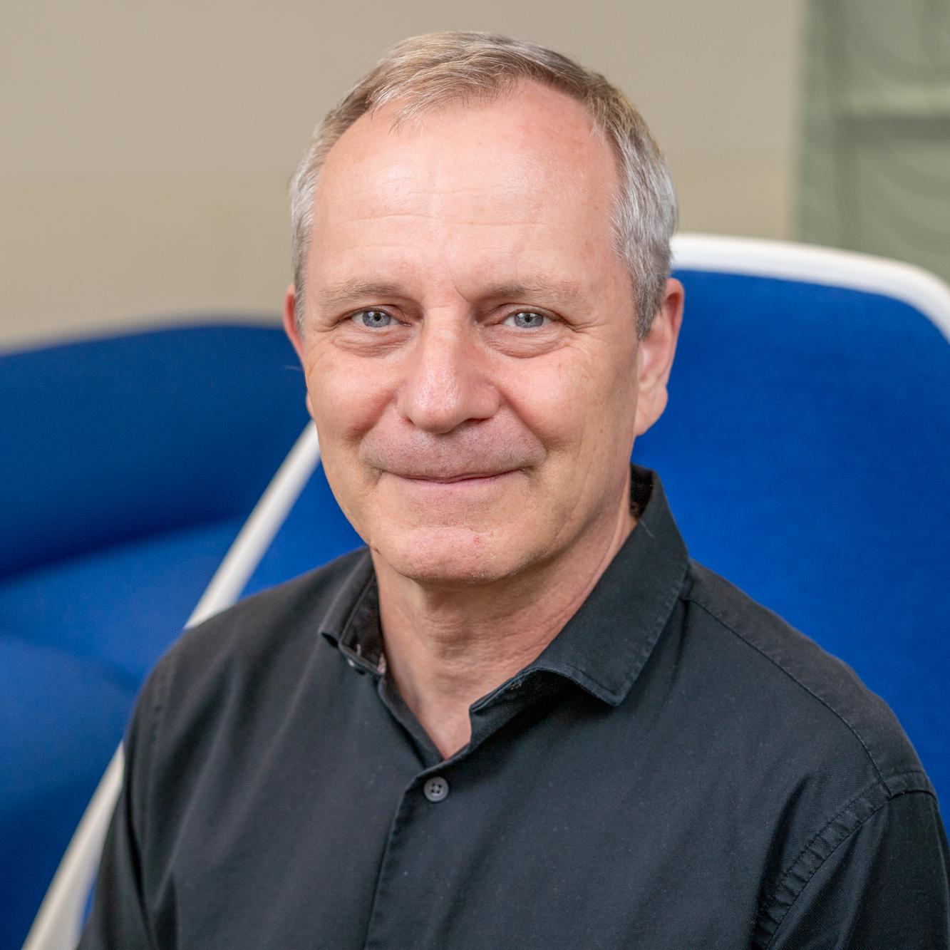 man sitting in a bright blue chair